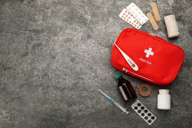 First aid kit on grey table, flat lay. Space for text