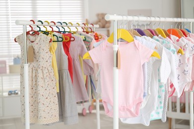 Baby clothes hanging on rack in store. Shopping concept