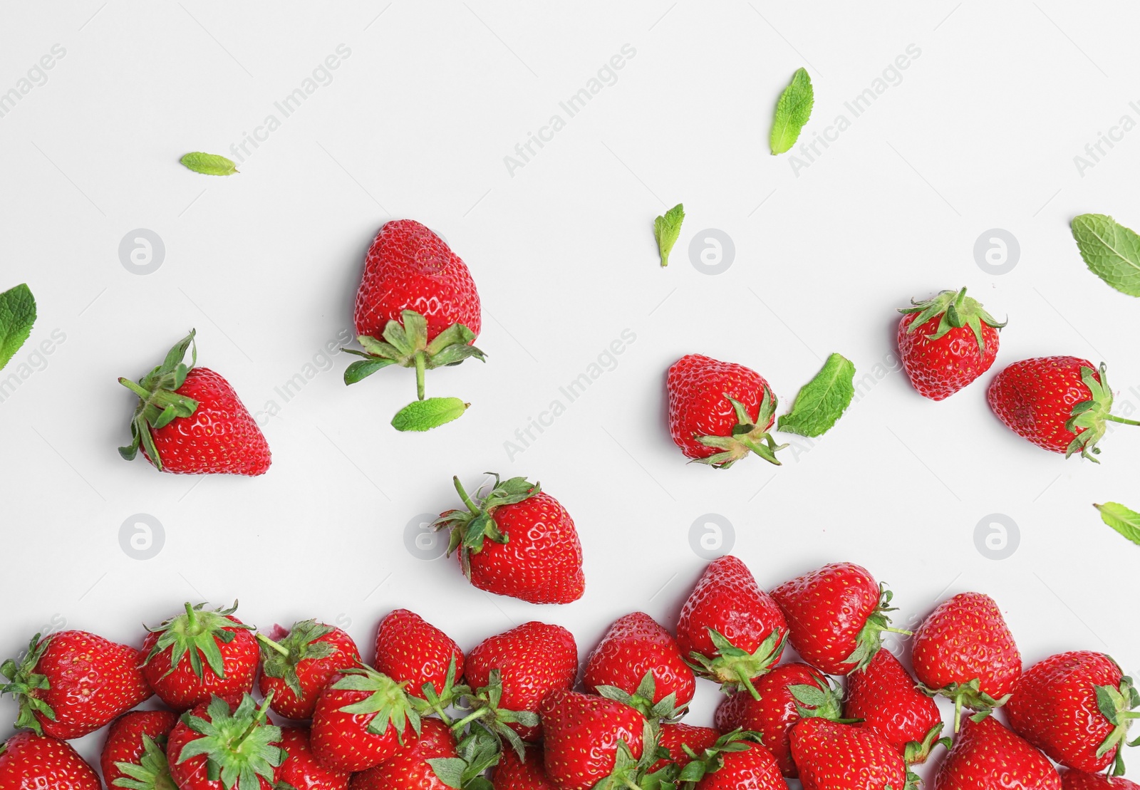 Photo of Composition with ripe red strawberries and mint on light background