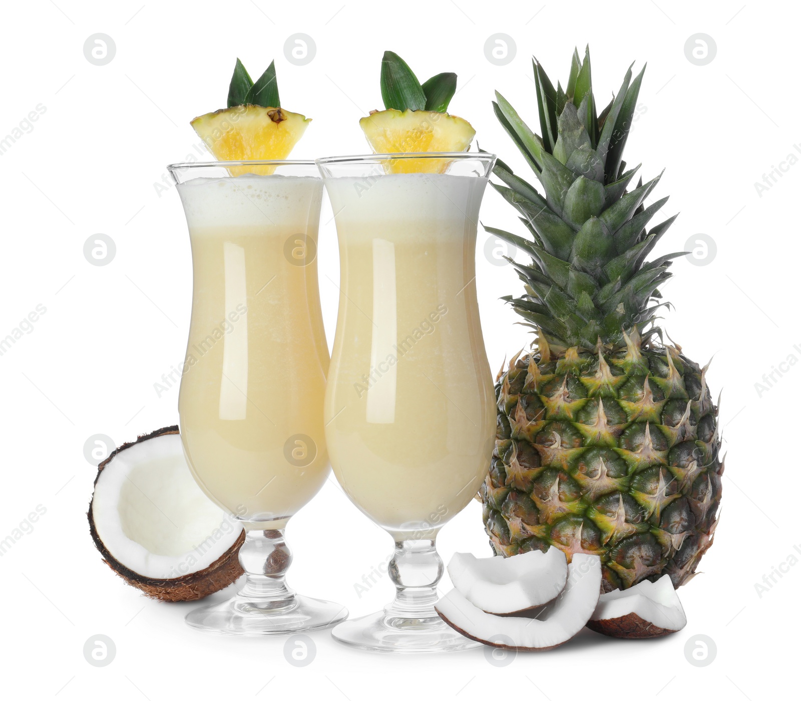 Photo of Tasty Pina Colada cocktail and ingredients on white background