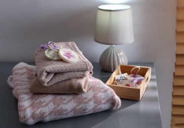 Beautiful scented wax sachets and clothes on grey table indoors