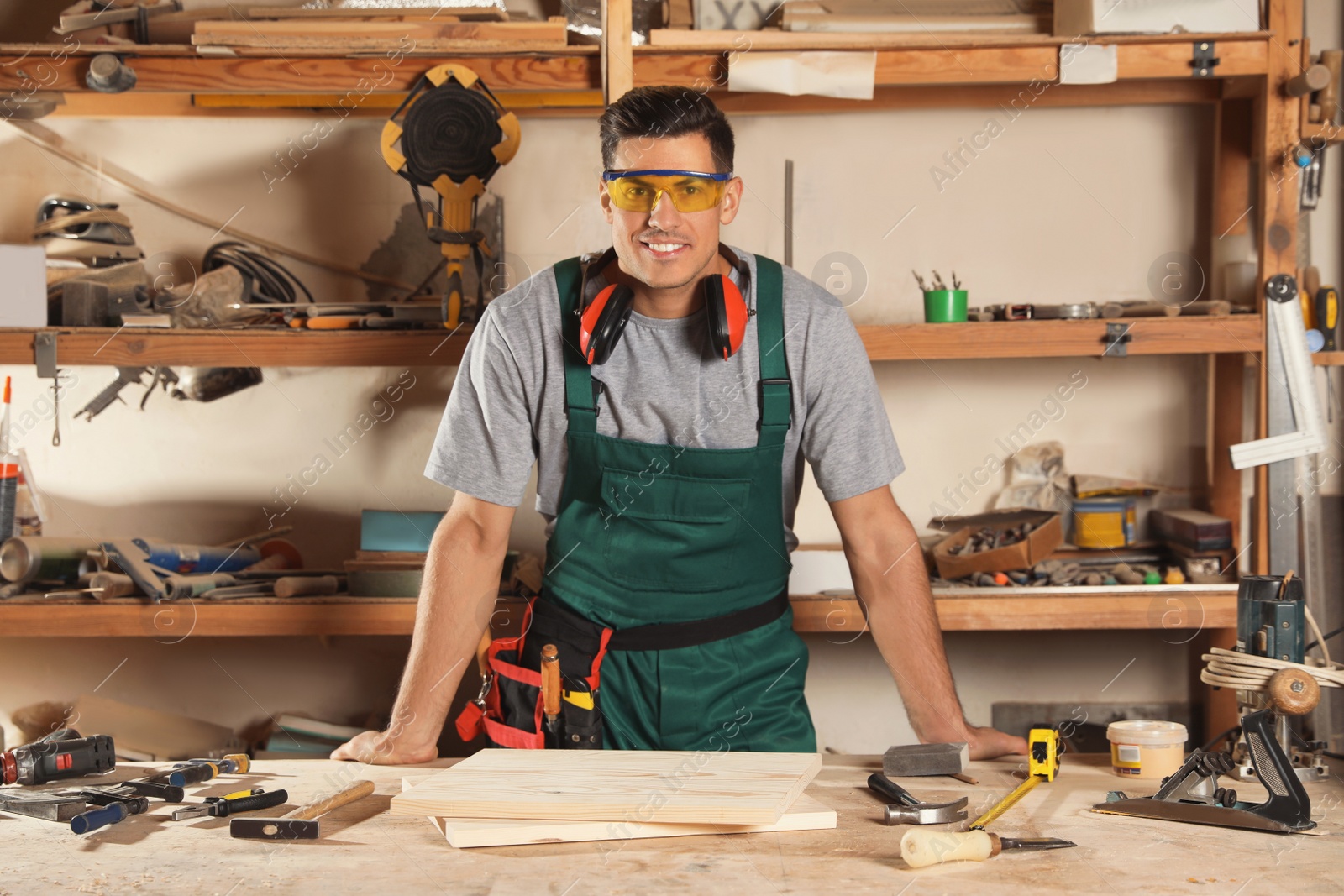 Photo of Professional carpenter with set of tools in workshop