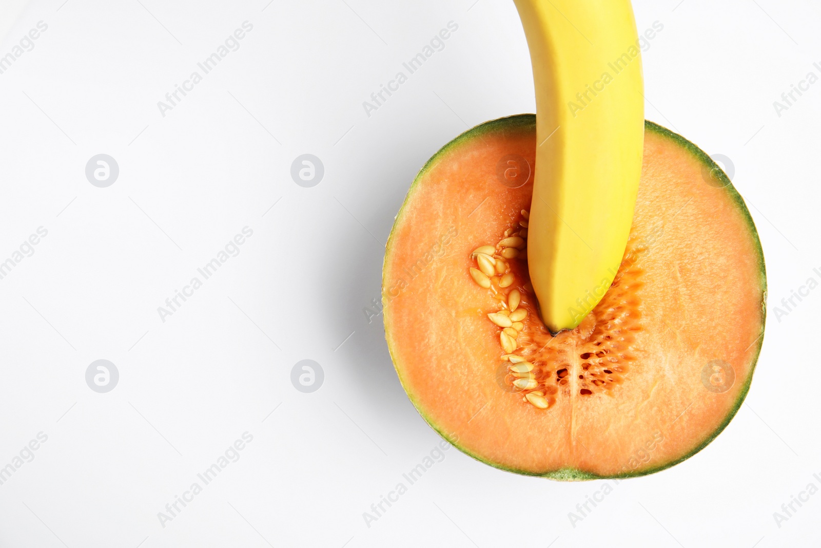 Photo of Fresh melon and banana on white background, top view. Sex concept
