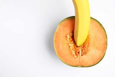 Fresh melon and banana on white background, top view. Sex concept