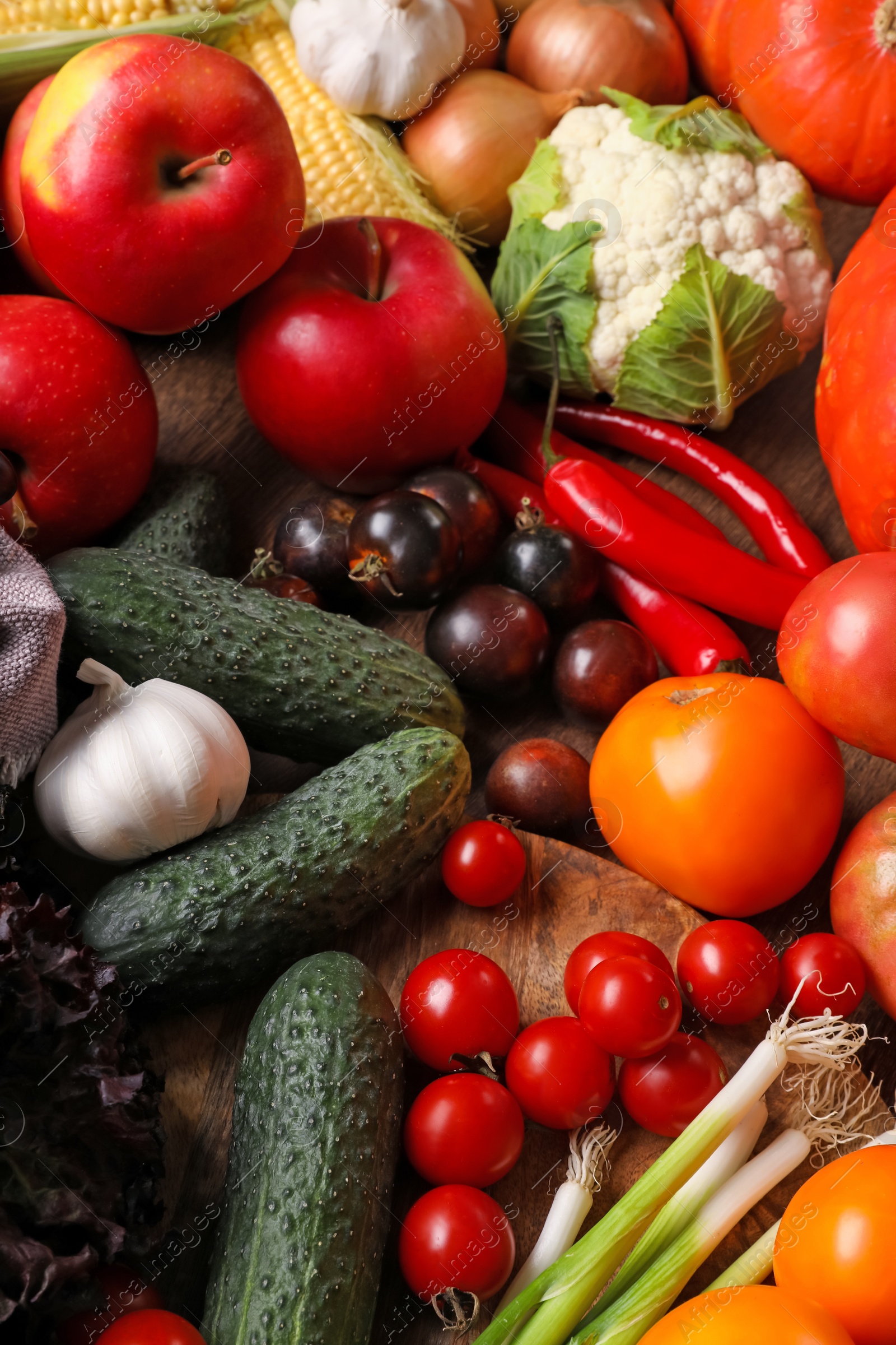 Photo of Different fresh ripe vegetables and fruits on wooden table, above view