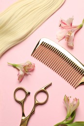 Hairdresser tools. Blonde hair lock, comb, scissors and flowers on pink background, flat lay