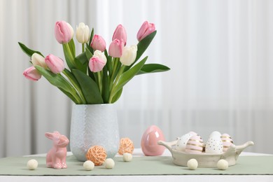 Photo of Composition with bouquet of tulips and Easter decorations on white table