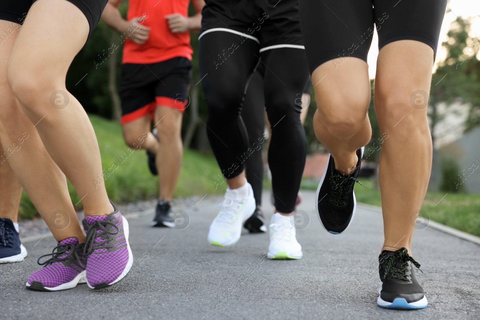 Photo of Group of people running outdoors, closeup view