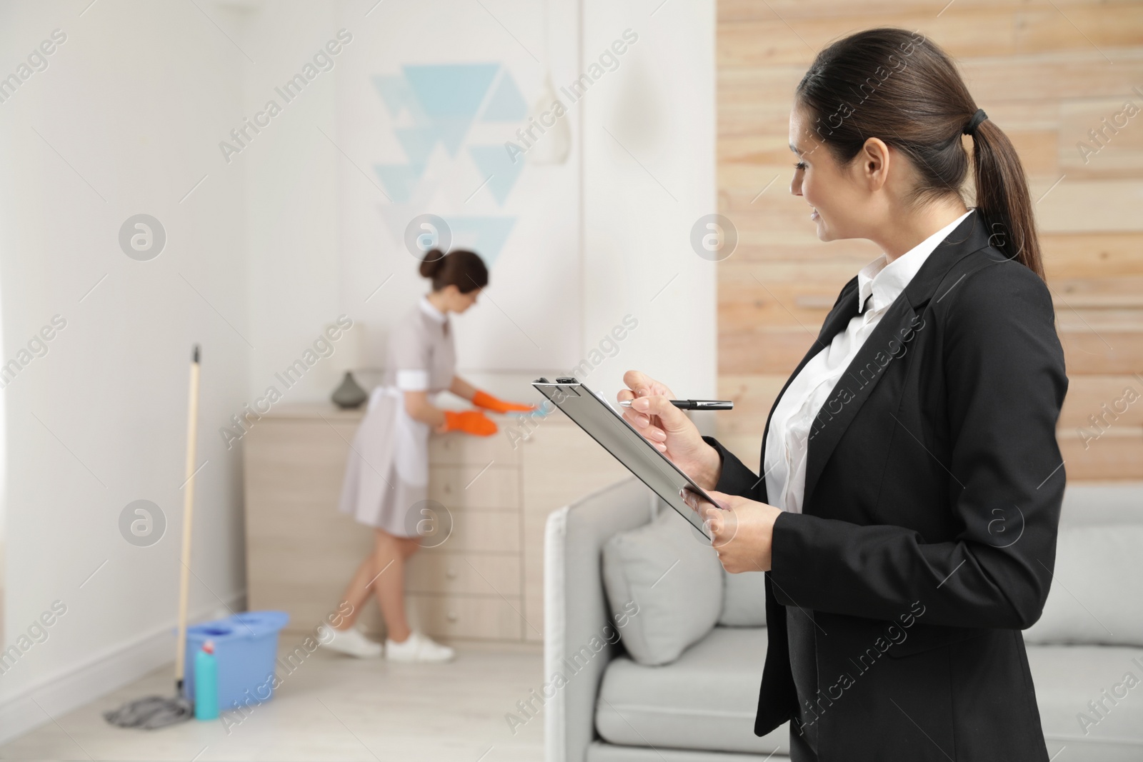 Photo of Housekeeping manager checking maid work in hotel room