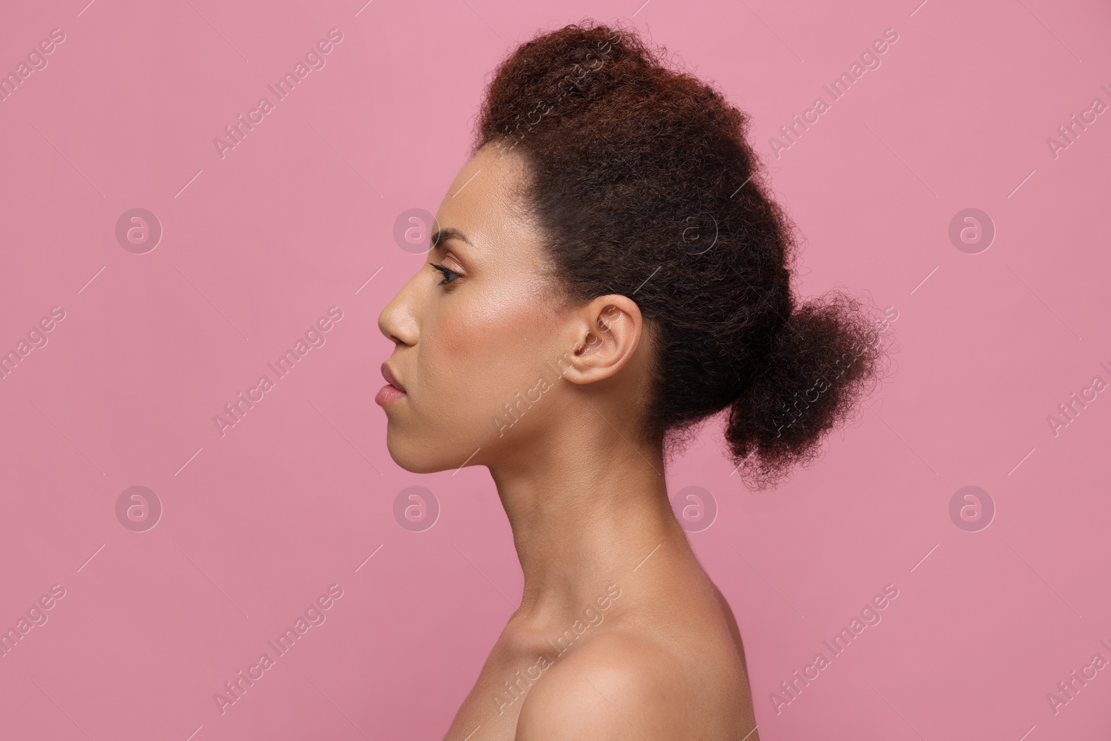 Photo of Beautiful young woman with glamorous makeup on pink background