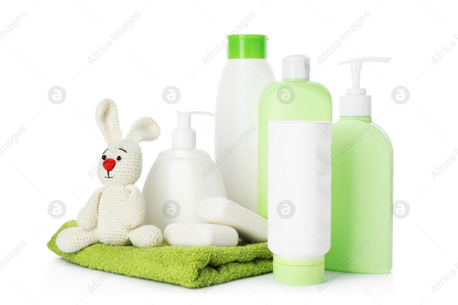 Photo of Baby cosmetic products, toy and towel on white background