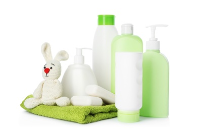 Photo of Baby cosmetic products, toy and towel on white background