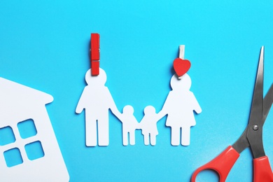 Photo of Paper silhouettes of family with pins, house and scissors on color background, flat lay. Life insurance concept