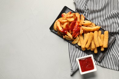 Photo of Delicious baked potato and cheese sticks with ketchup on light grey table, flat lay. Space for text