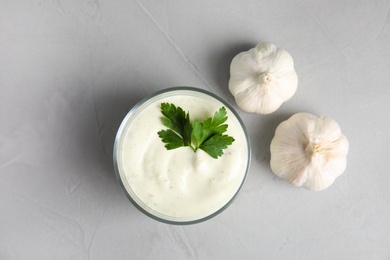 Photo of Flat lay composition with garlic sauce on grey background