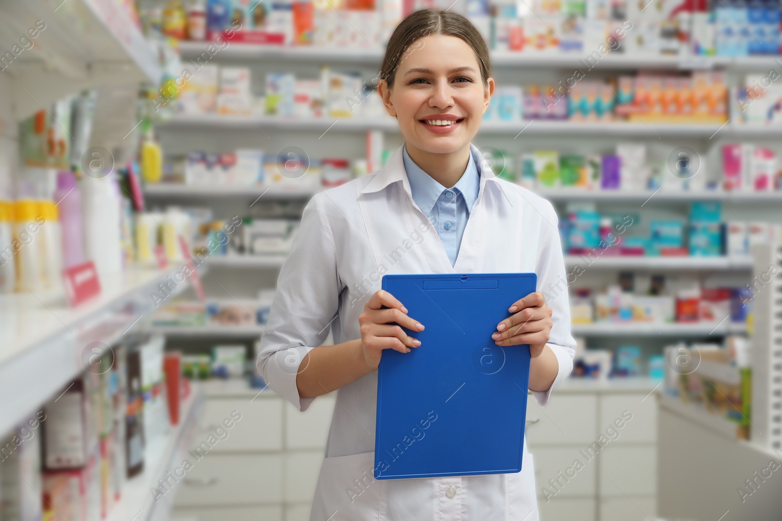 Photo of Professional pharmacist with clipboard in modern drugstore