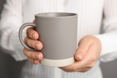 Photo of Woman holding mug of hot drink, closeup. Coffee Break