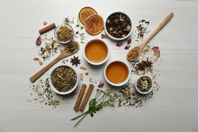 Flat lay composition with fresh brewed tea and dry leaves on wooden table