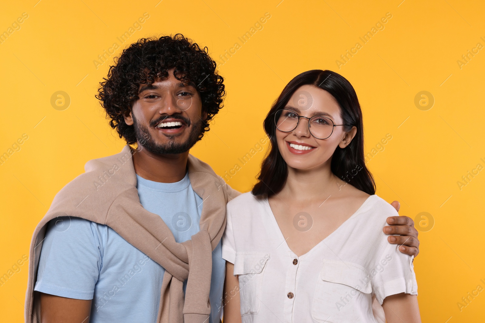 Photo of International dating. Portrait of happy couple on yellow background