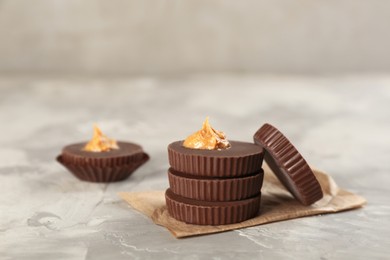 Photo of Delicious peanut butter cups on light grey table
