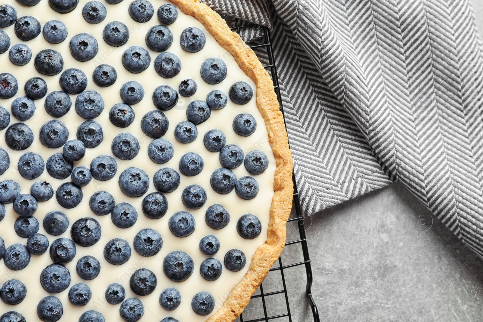 Photo of Flat lay composition with tasty blueberry cake on gray table