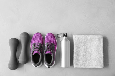 Photo of Flat lay composition with fitness equipment and space for text on gray background