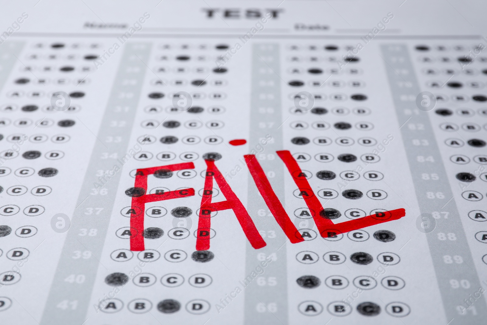 Photo of Word Fail written with red marker on answer sheet, closeup. Student passing exam