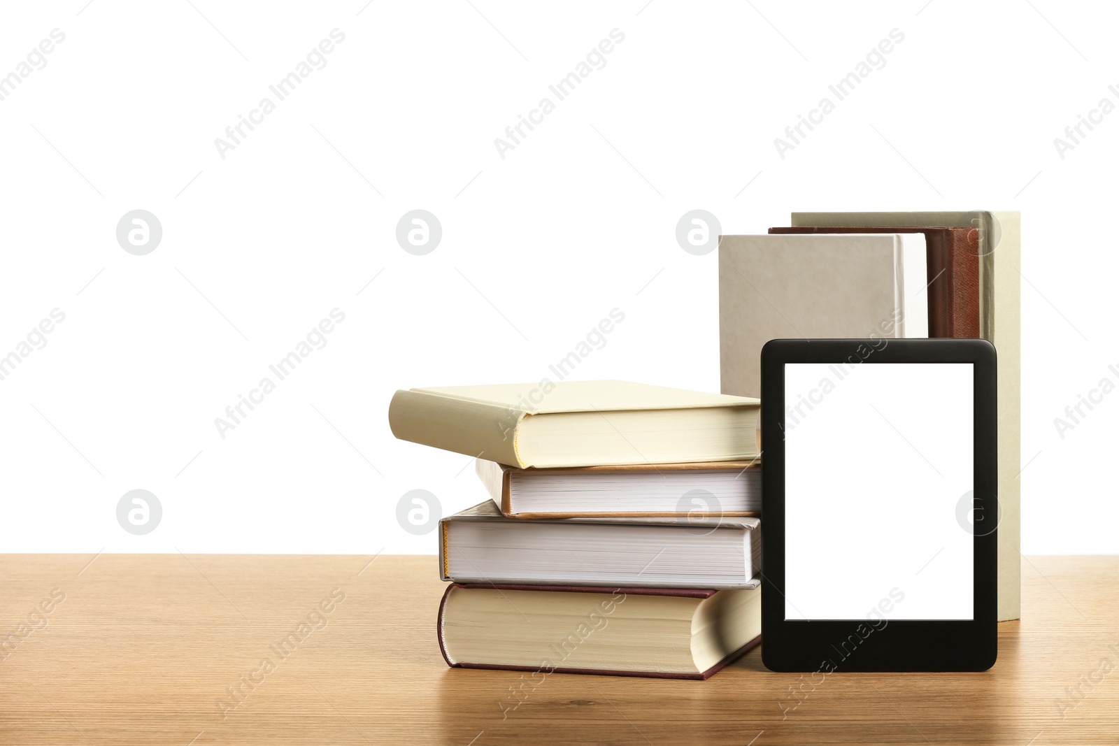Photo of Hardcover books and modern e-book on wooden table against white background. Space for text