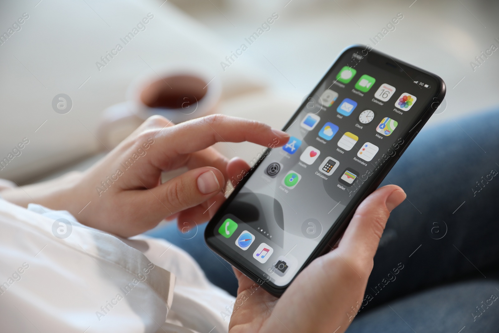 Photo of MYKOLAIV, UKRAINE - MARCH 16, 2020: Woman holding iPhone 11 with home screen indoors, closeup