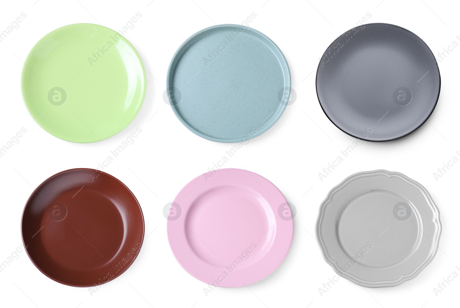 Image of Set of different ceramic plates on white background, top view