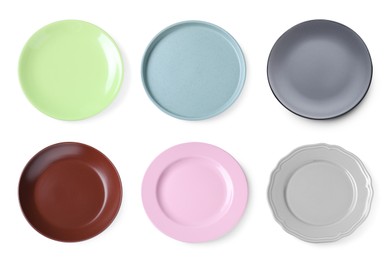 Image of Set of different ceramic plates on white background, top view