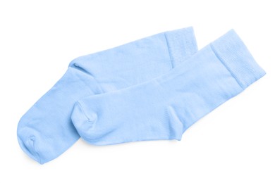 Photo of Pair of light blue socks on white background, top view