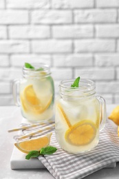 Photo of Mason jars of natural lemonade on table