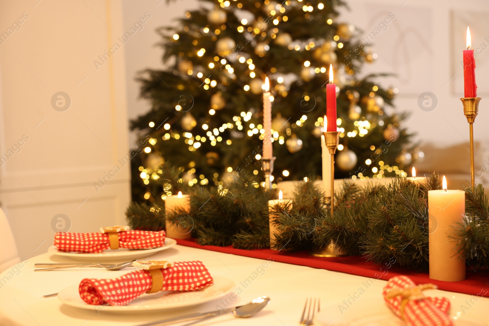 Photo of Festive table setting and beautiful Christmas decor in room. Interior design