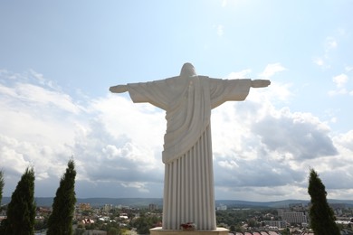 Truskavets, Ukraine - July 22, 2023: Statue of Christ the Redeemer against beautiful cityscape