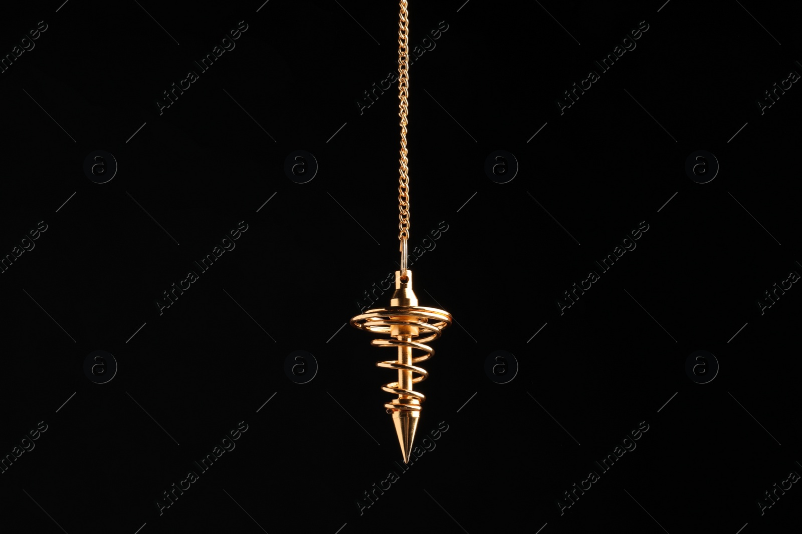 Photo of Beautiful golden pendulum with chain on black background. Hypnosis session