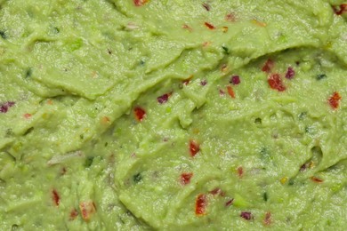 Photo of Delicious fresh guacamole as background, top view