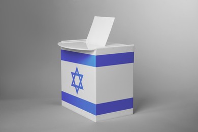 Image of Ballot box decorated with flag of Israel on light background