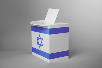 Ballot box decorated with flag of Israel on light background