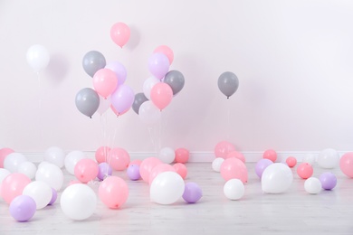 Photo of Room decorated with colorful balloons near wall