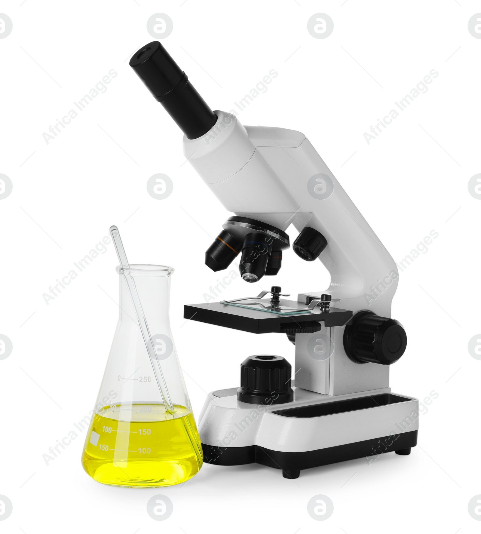 Photo of Laboratory flask with yellow liquid and microscope isolated on white