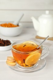 Glass cup of immunity boosting drink on white wooden table