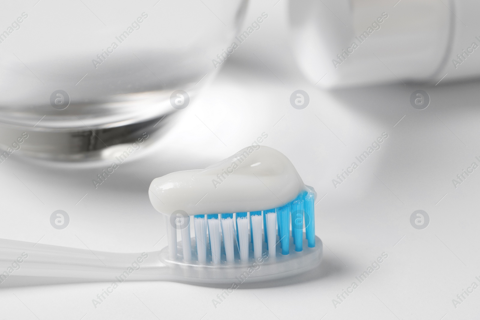 Photo of Plastic toothbrush with paste on white background, closeup