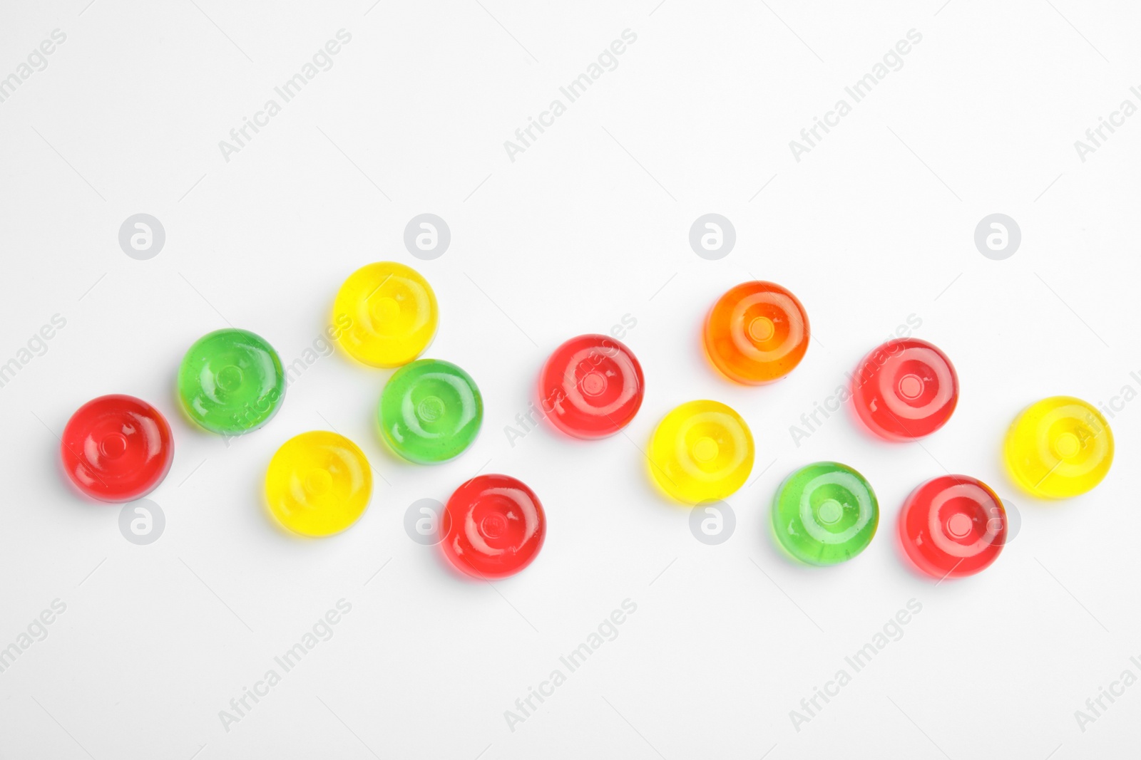 Photo of Delicious colorful candies on white background, top view