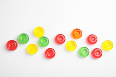 Photo of Delicious colorful candies on white background, top view