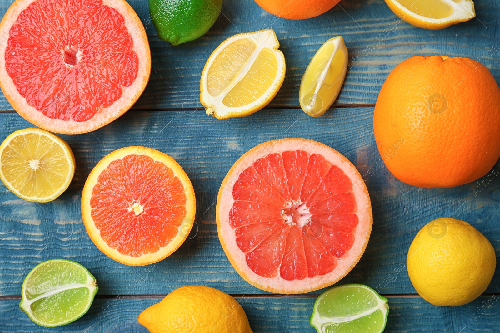 Photo of Many fresh citrus fruits on wooden table