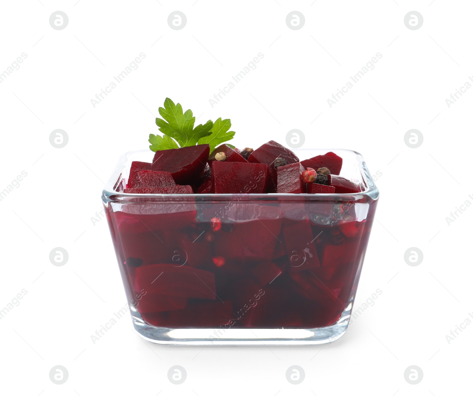 Photo of Pickled beets with parsley in glass bowl isolated on white