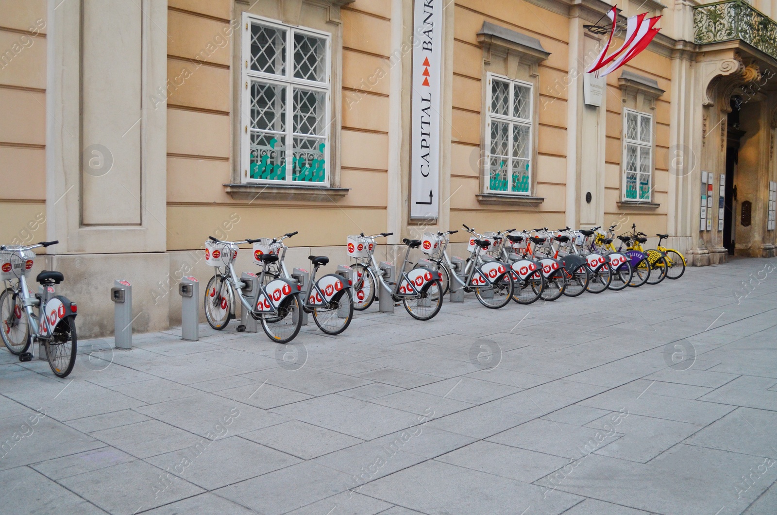 Photo of VIENNA, AUSTRIA - JUNE 18, 2018: Bicycles parked near building on city street