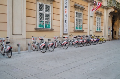 Photo of VIENNA, AUSTRIA - JUNE 18, 2018: Bicycles parked near building on city street