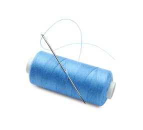 Photo of Spool of light blue sewing thread with needle isolated on white